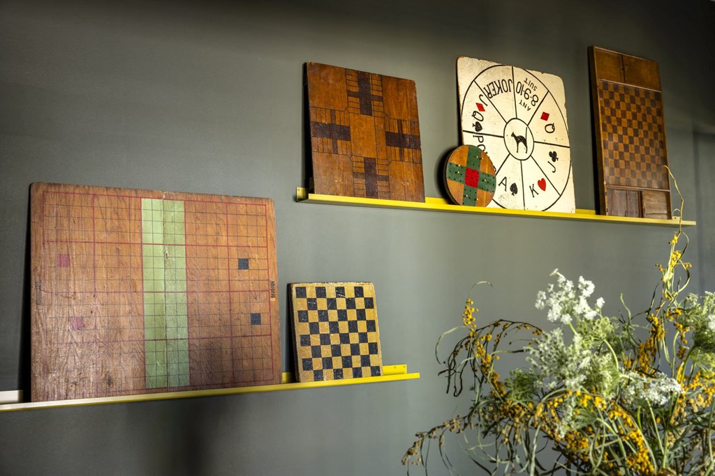 a shelf with a clock and games on it