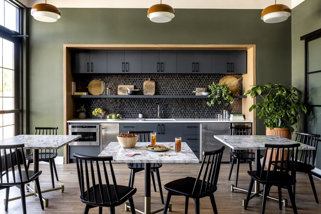 a kitchen and dining room with tables and chairs