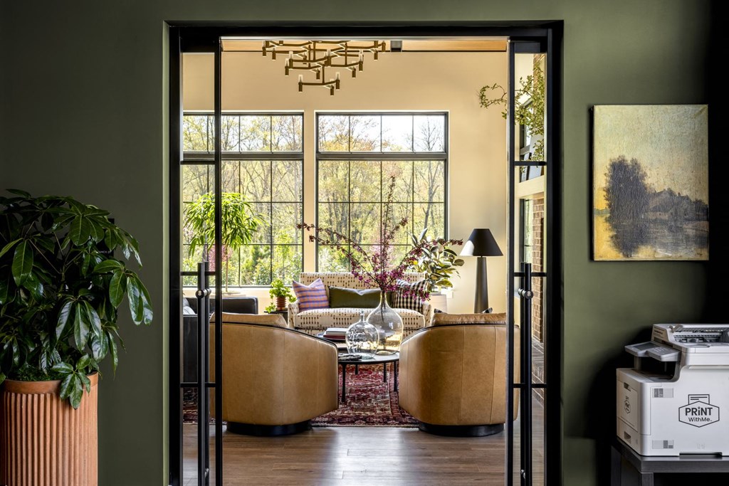 a living room with two couches and a table and a large window