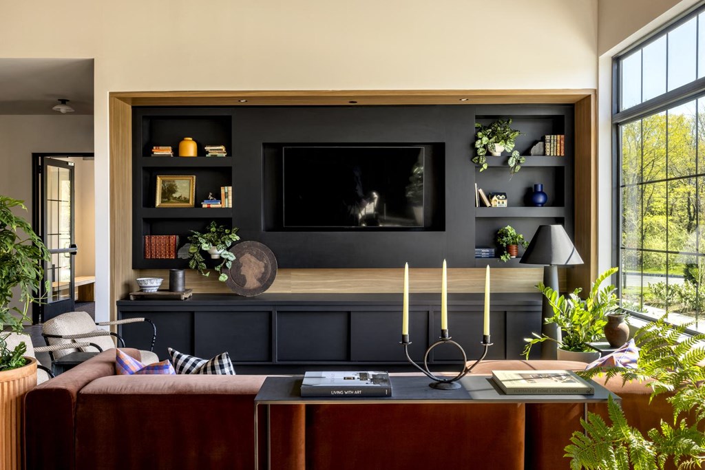 a row of potted plants in front of a window