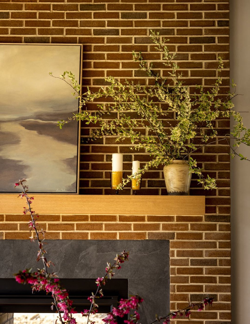 a brick fireplace with a plant on top of it
