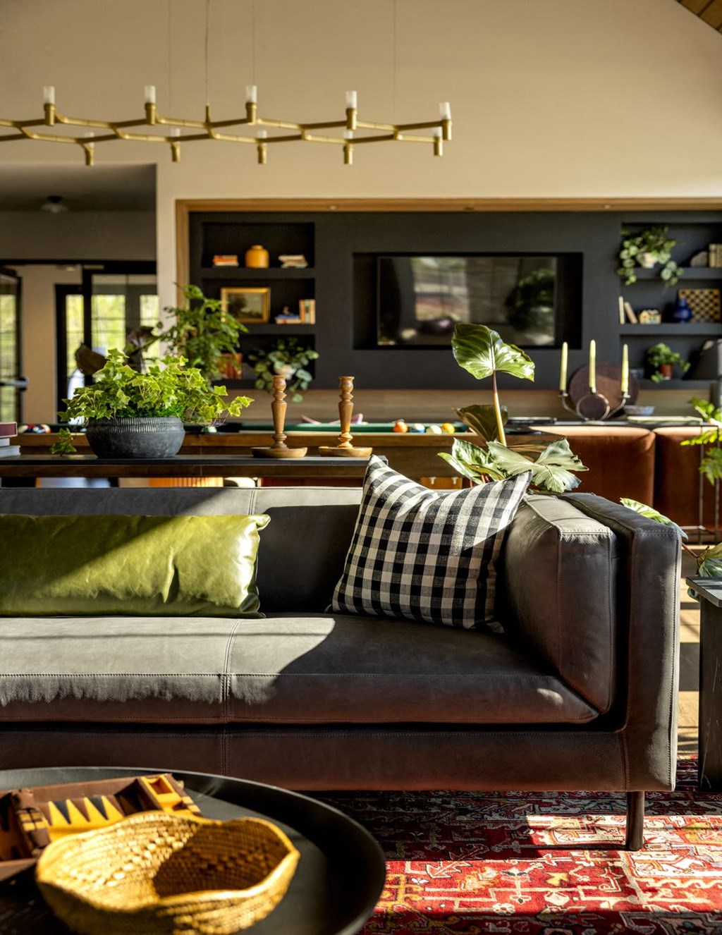 a living room with a couch and a table with plants