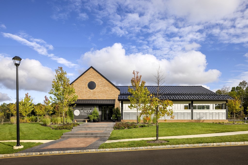 A building with a sign that says "Teacon Hill" is in front of a cloudy sky.