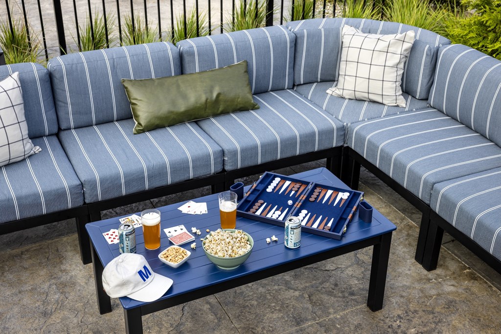 A blue sofa with a tray of snacks and drinks on a coffee table.