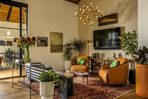 A living room with a striped sofa and a chandelier.