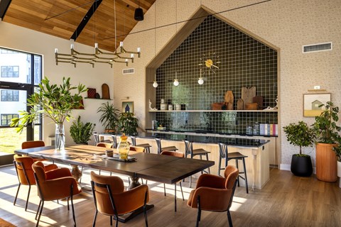 A modern dining room with a wooden table and chairs.