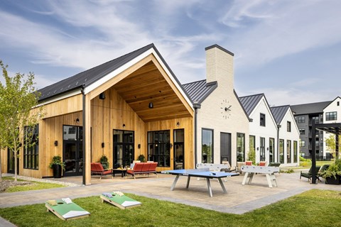 A modern house with a wooden exterior and a black roof.