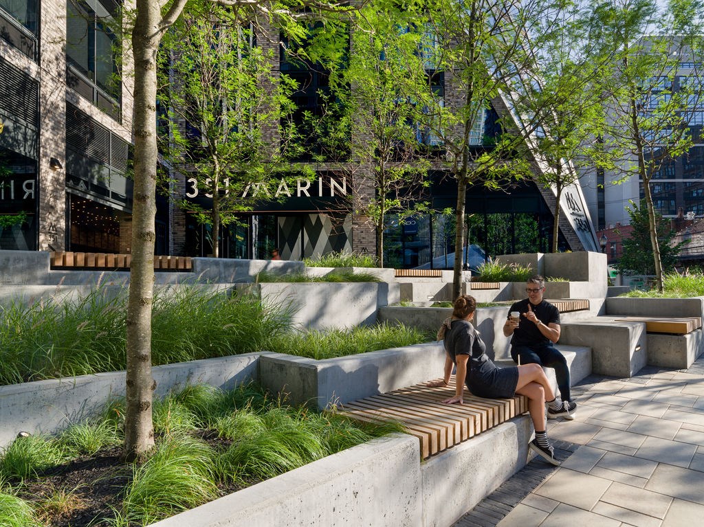 people sitting on a bench in front of the building