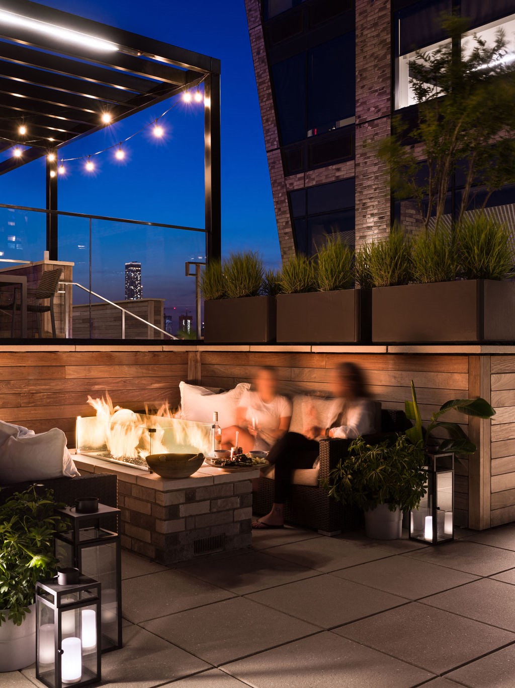 a fire pit on the patio of a building at night