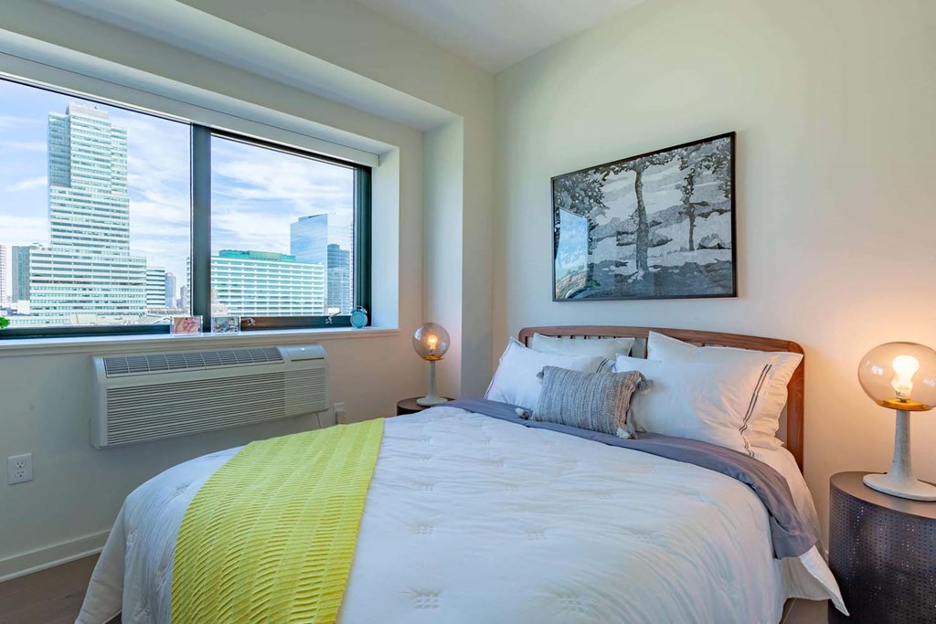 a bedroom with a bed and a window