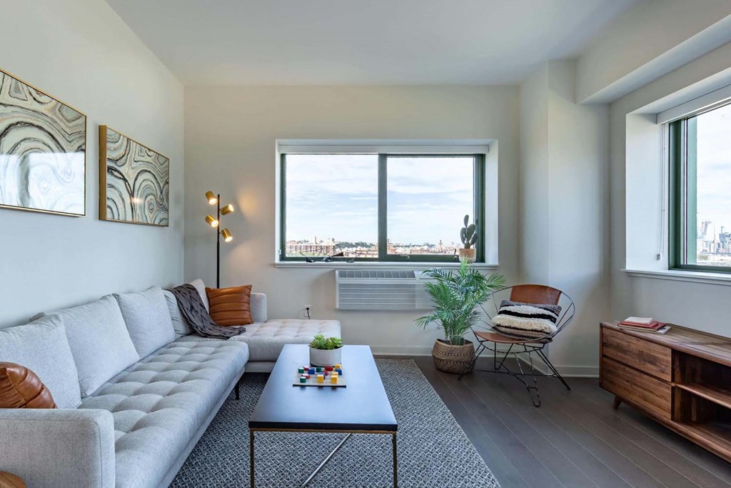 a living room with a couch and a table and a window