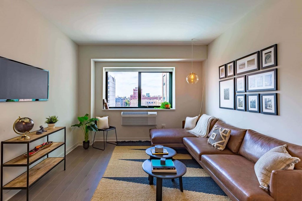 a living room with a leather couch and a tv
