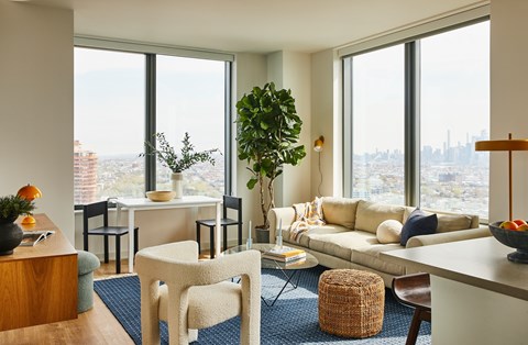 a living room with a couch and a view of the city