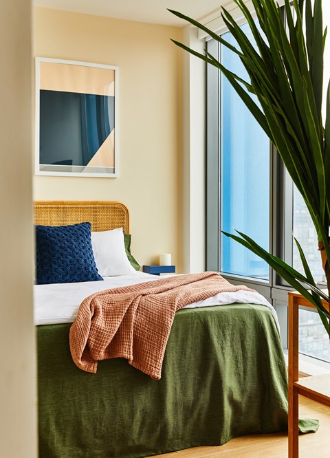 a bedroom with a bed and a large window