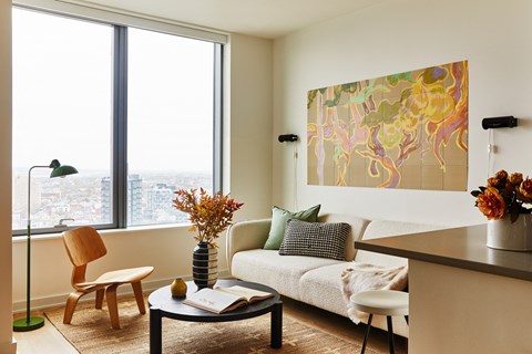 a living room with a couch and a table and a window