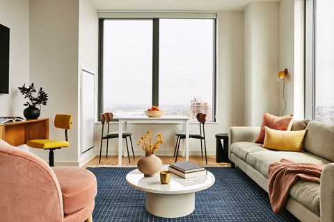 a living room with a large window and a couch and a table