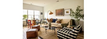 A living room with a sofa, armchairs, and a coffee table.
