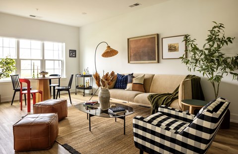 A living room with a sofa, armchairs, and a coffee table.