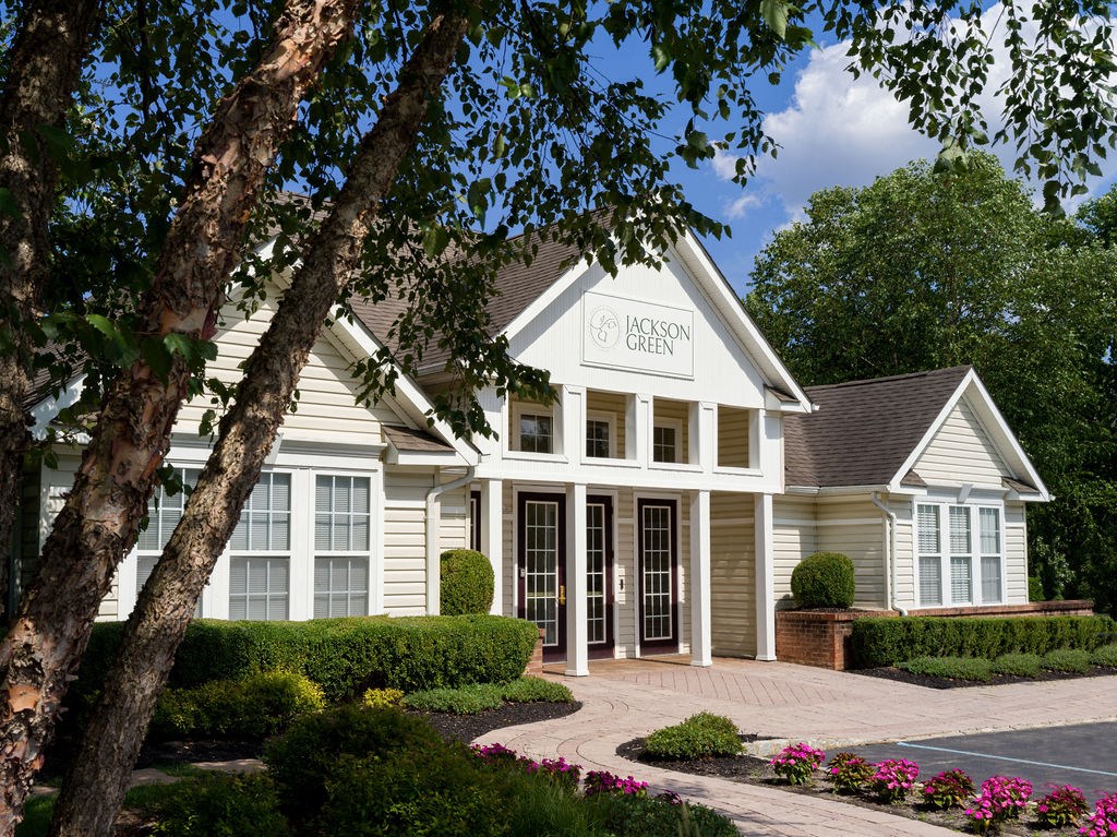 a white building with a tree in front of it