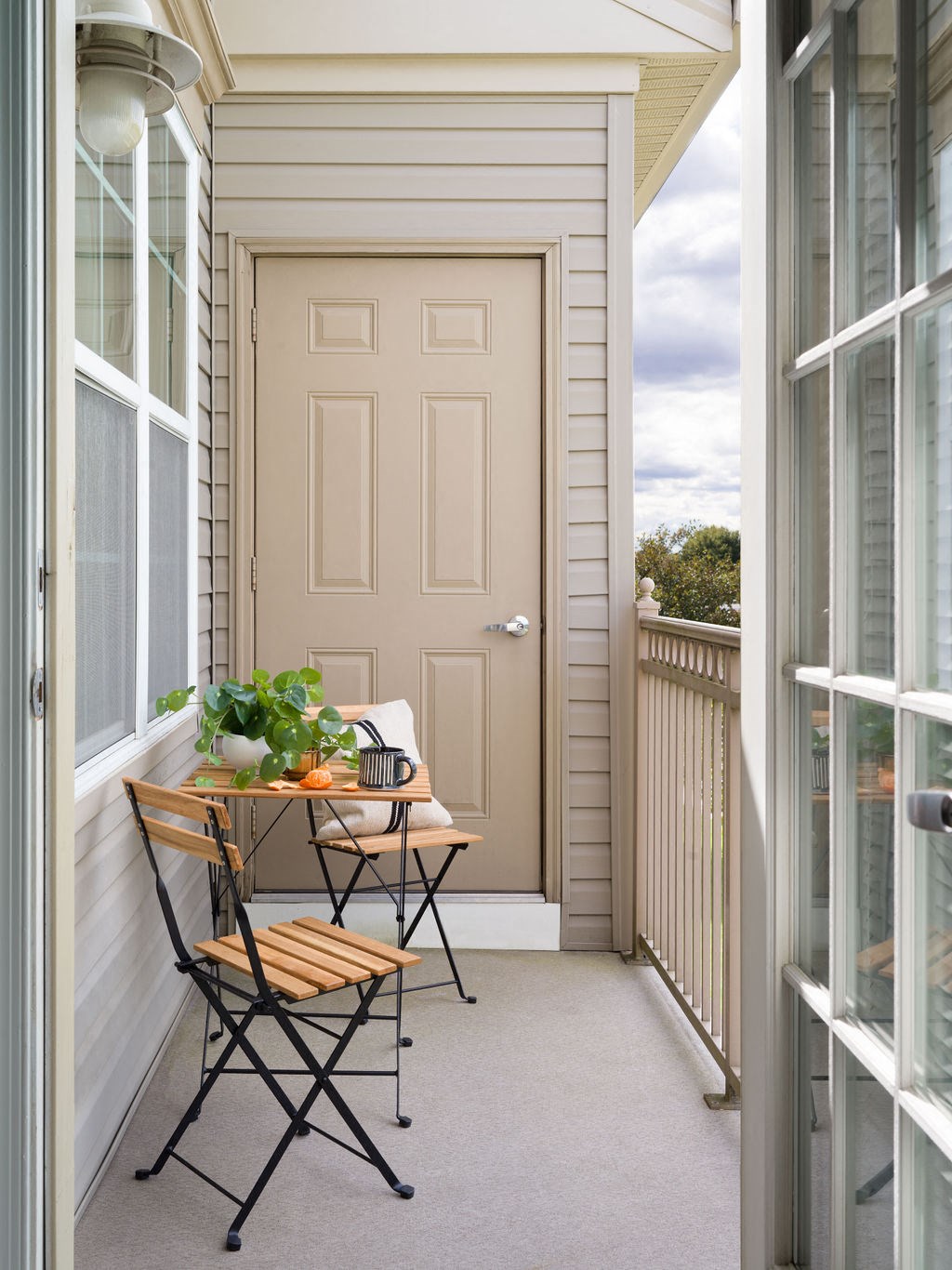 a small porch with a table and chairs and a door
