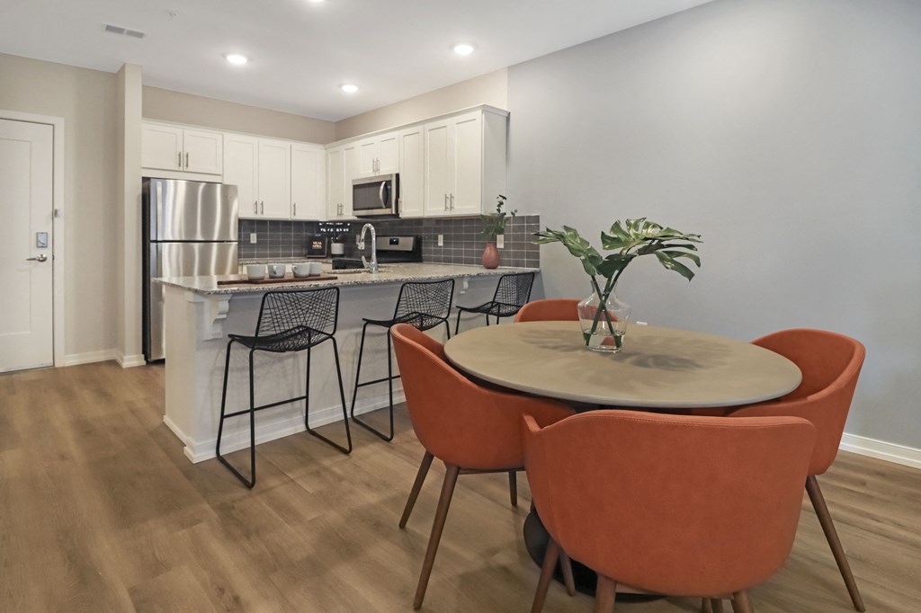 a kitchen with an island and a table with chairs