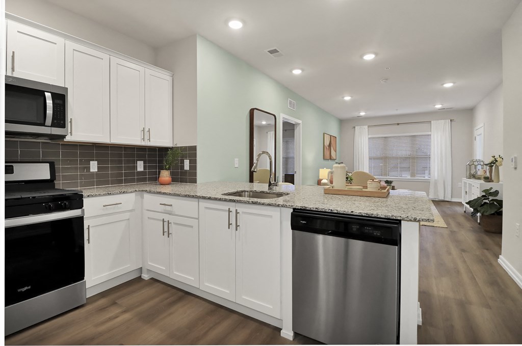 a kitchen with white cabinets and a counter top