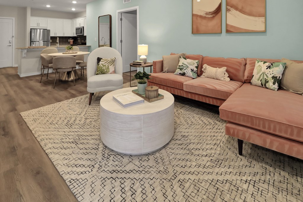 a living room with a pink couch and a coffee table