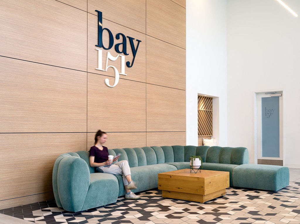 a woman sits on a couch in the lobby of a day spa