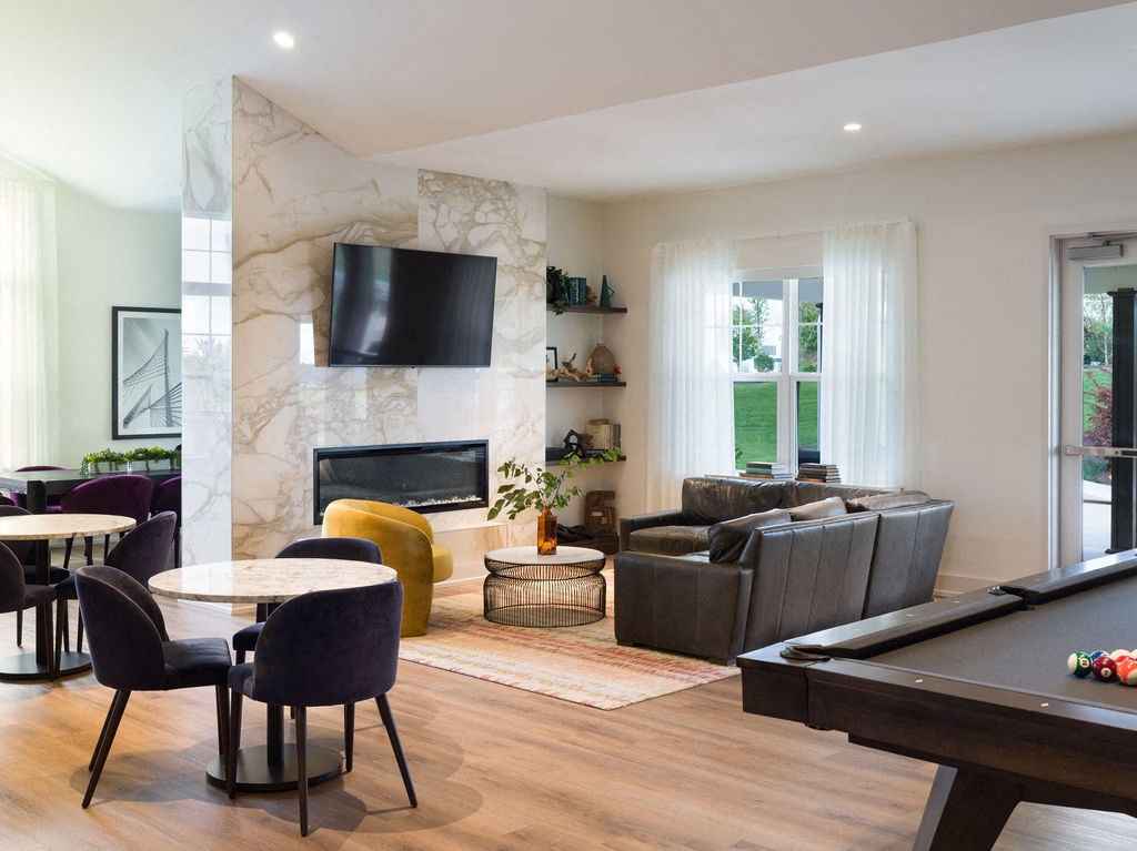 a living room with a pool table and a tv