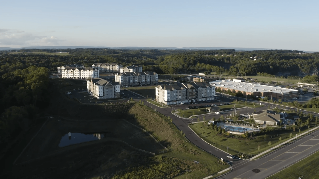 an aerial view of a campus with buildings and a river