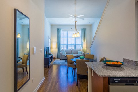 A modern kitchen with a dining table and chairs.