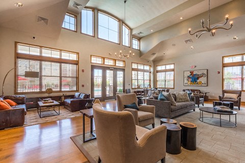 A living room with a brown chair and a grey couch.