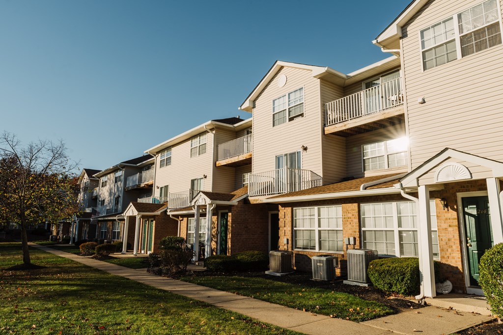a row of houses with a sidewalk in front of them