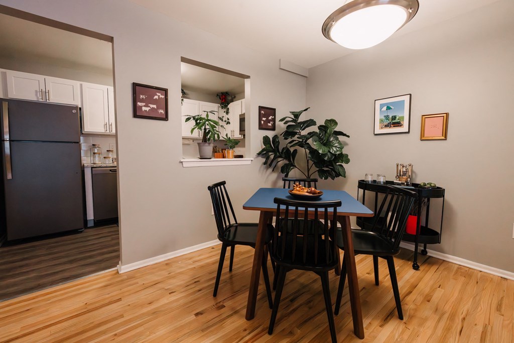 a dining room with a table and chairs and a kitchen