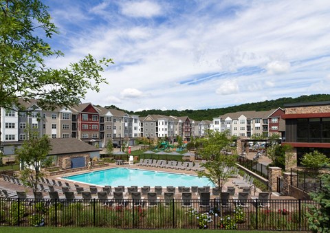 an aerial view of an apartment complex with a swimming pool
