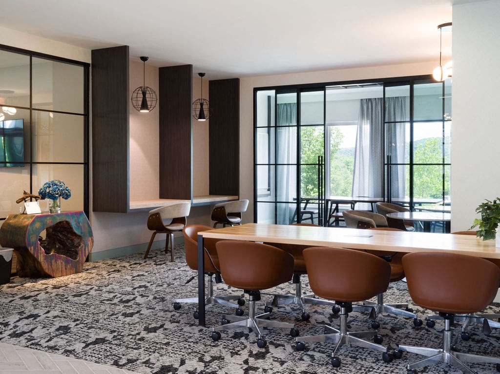 a conference room with a wooden table and chairs
