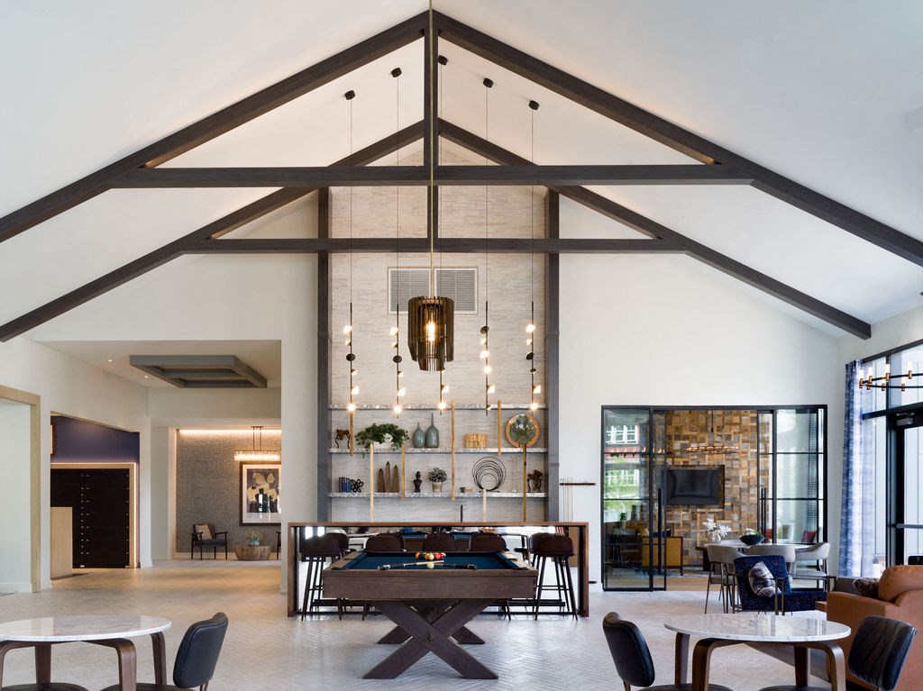 a large room with tables and chairs and a fireplace