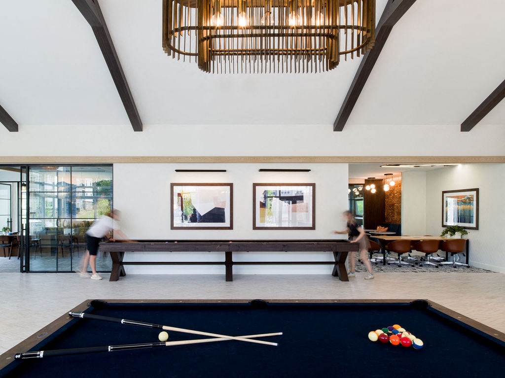 a game room with a pool table and a chandelier