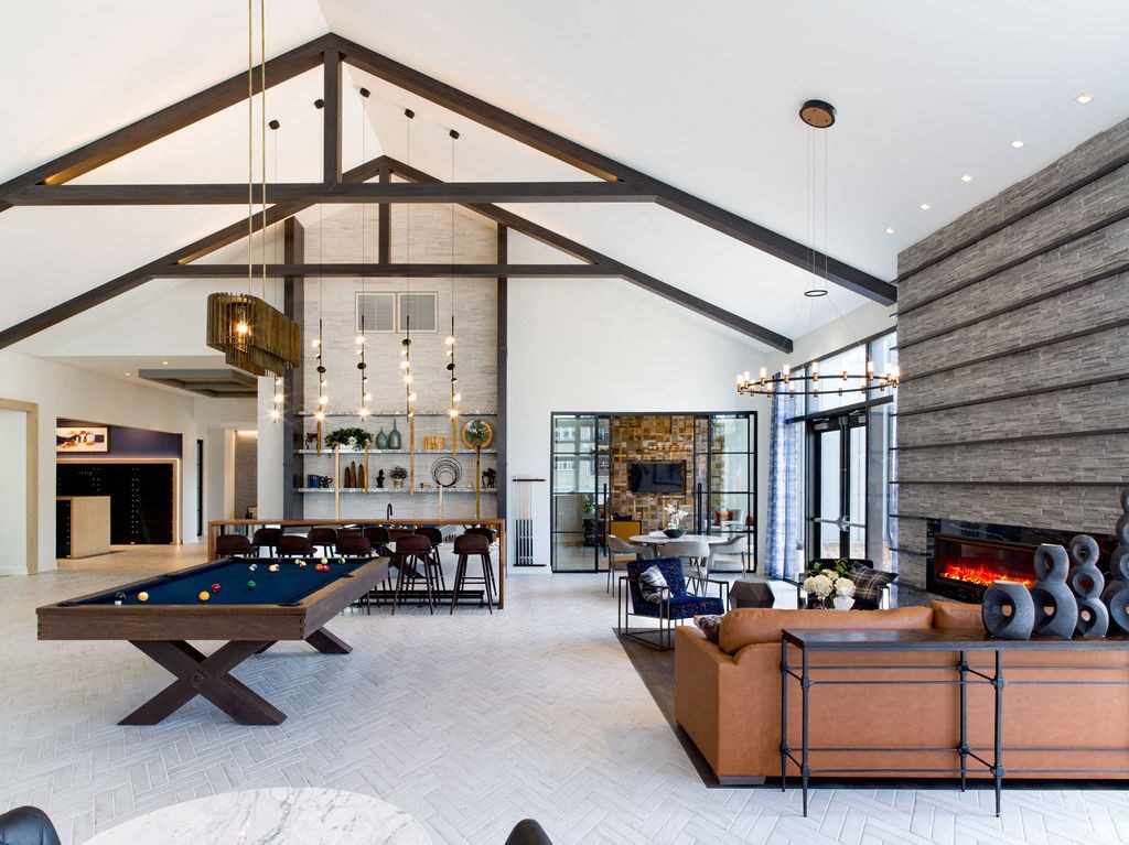 a large living room with a pool table and a fireplace