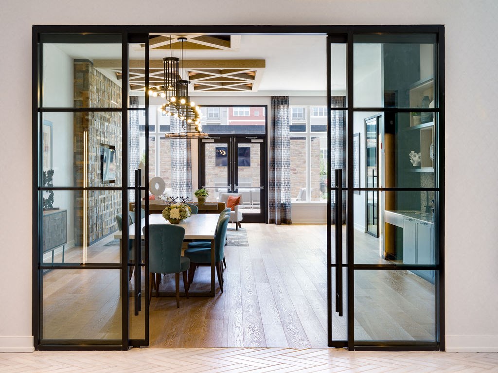 a dining room with glass doors and a table and chairs