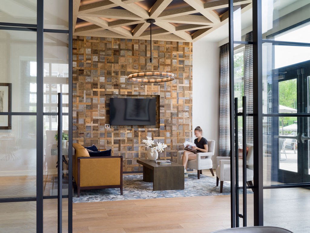 a man sitting on a couch in a living room with a fireplace