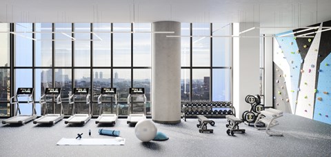 a gym with floor to ceiling windows and weights and yoga machines