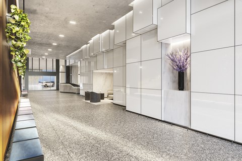 the lobby of a building with white walls and a gray floor