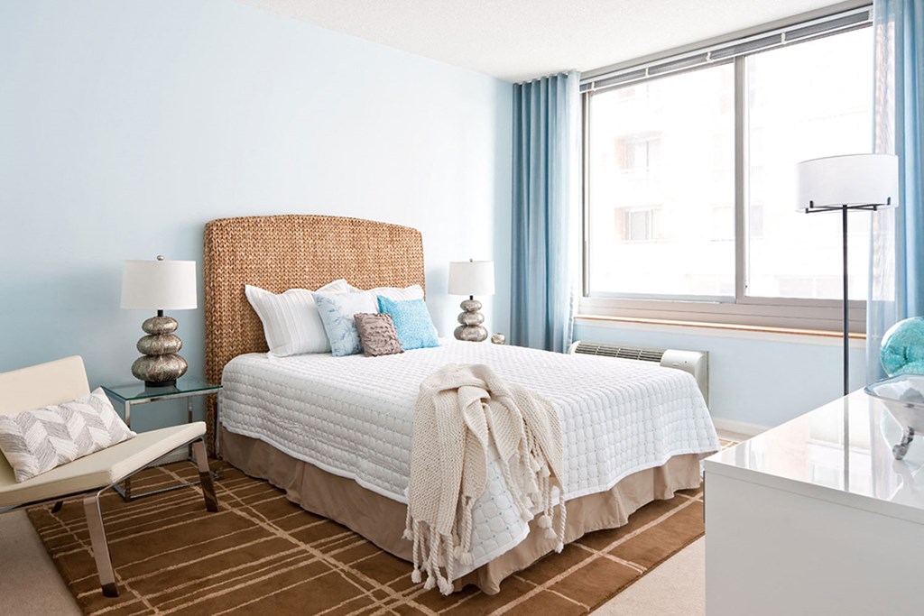 a bedroom with a bed and two windows