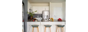 a kitchen with a counter top and a refrigerator