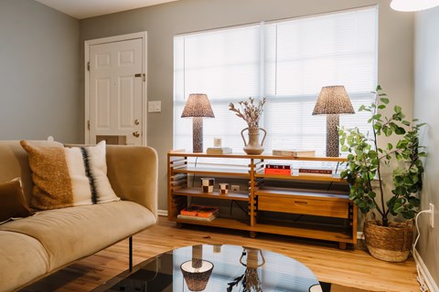 a living room with a couch and a table and a window
