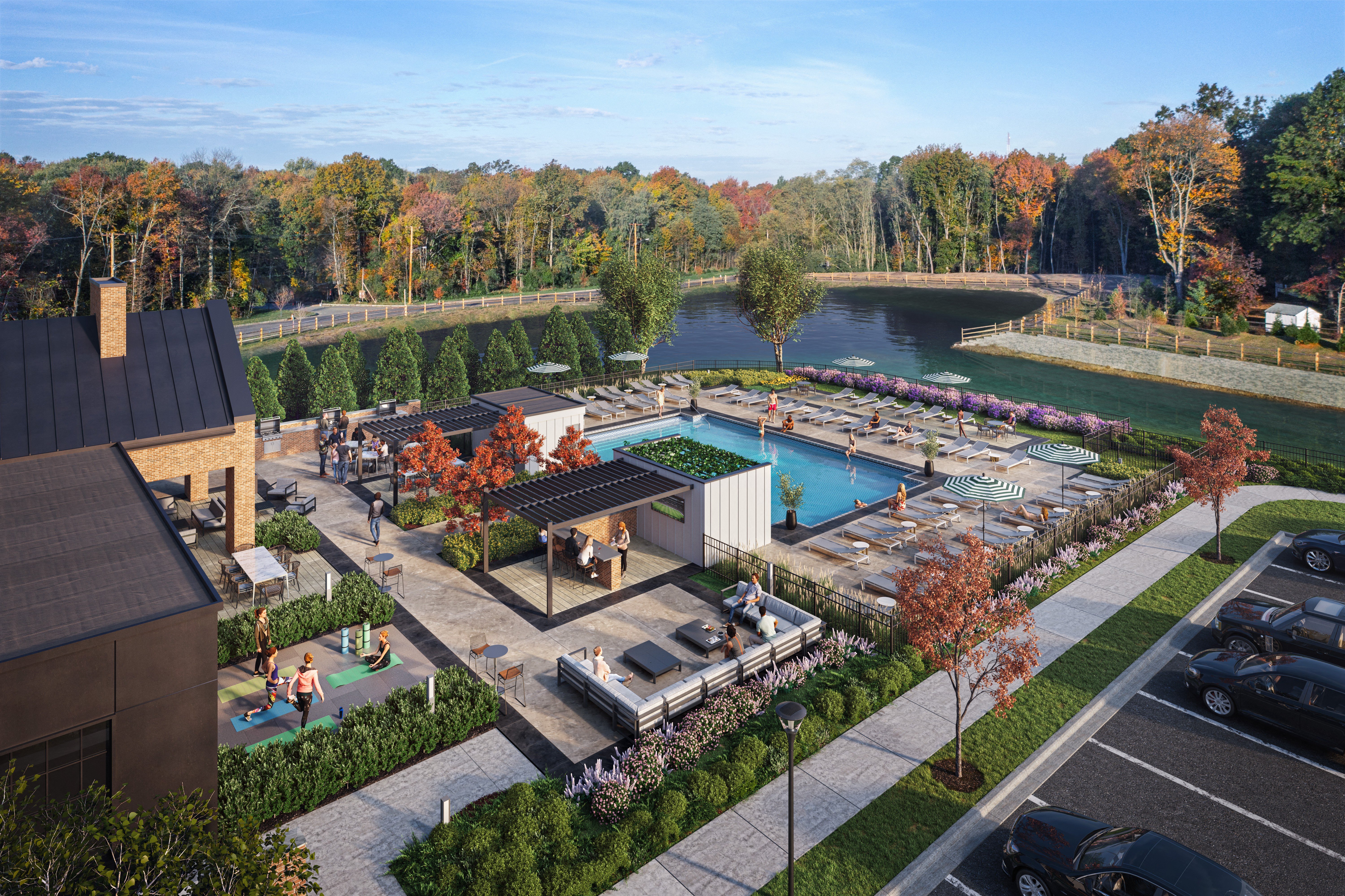 an aerial view of a resort with a pool and a lake