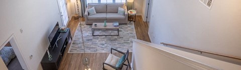 A living room with a grey couch and a coffee table.