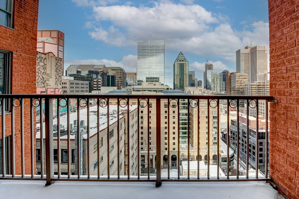 a balcony with a view of the skyline of a city