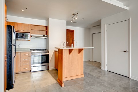a kitchen with wooden cabinets and stainless steel appliances